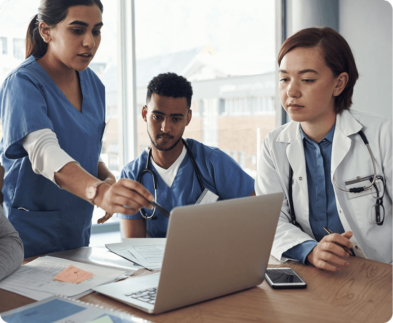 medical professionals discussing hypochondroplasia at a meeting with a laptop